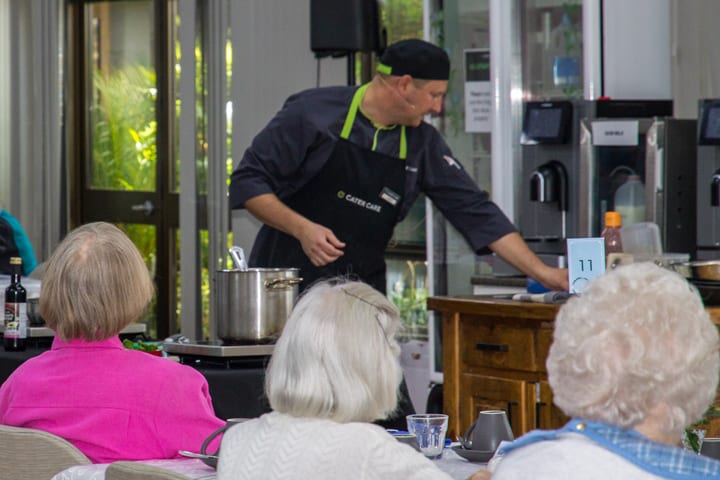 Residents watching the cooking demonstration at Yukana
